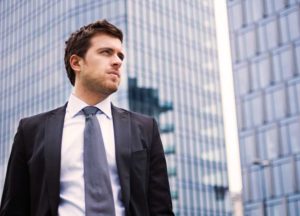 Executive standing in front of building